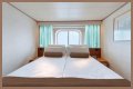 An old Holland America cruise ship is turning residential, letting travelers live at sea for $8,000 a month while it circumnavigates the globe